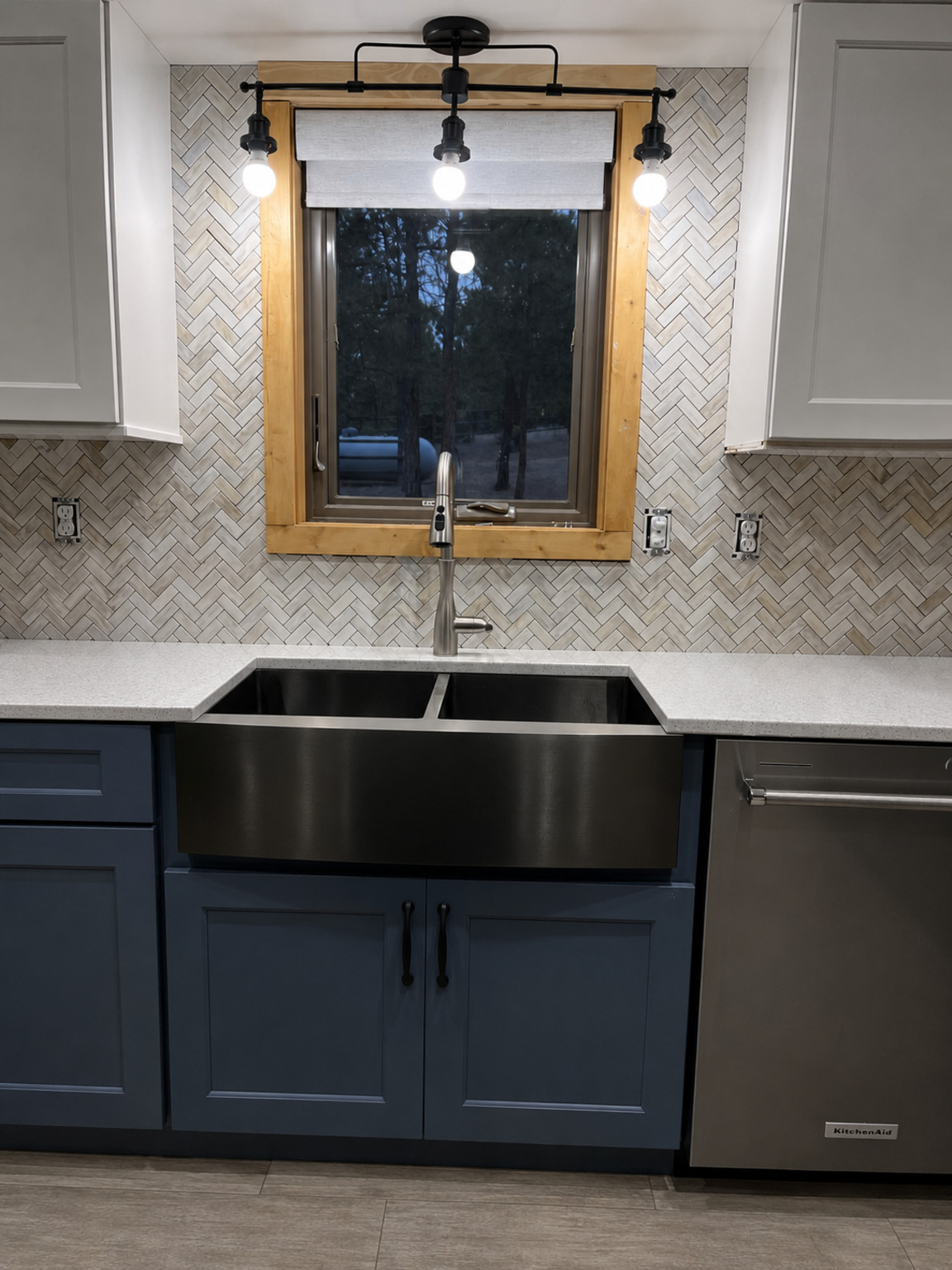 Finished Lucky13 herringbone tile backsplash around a farmhouse sink